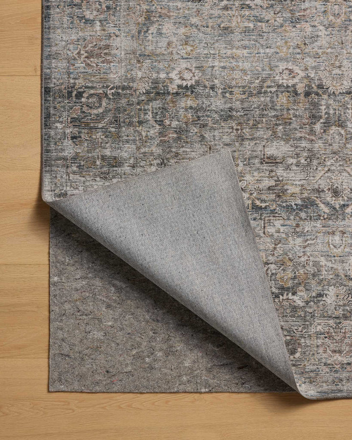 patterned rug with brown , blue, and burnt orange neutral tones