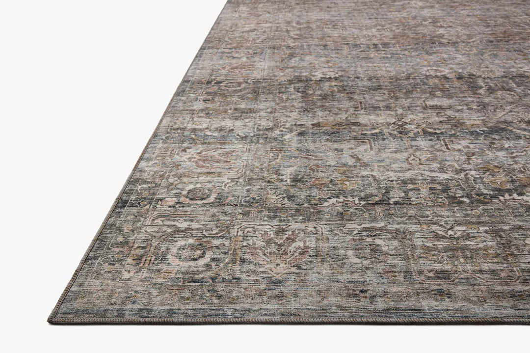 patterned rug with brown , blue, and burnt orange neutral tones