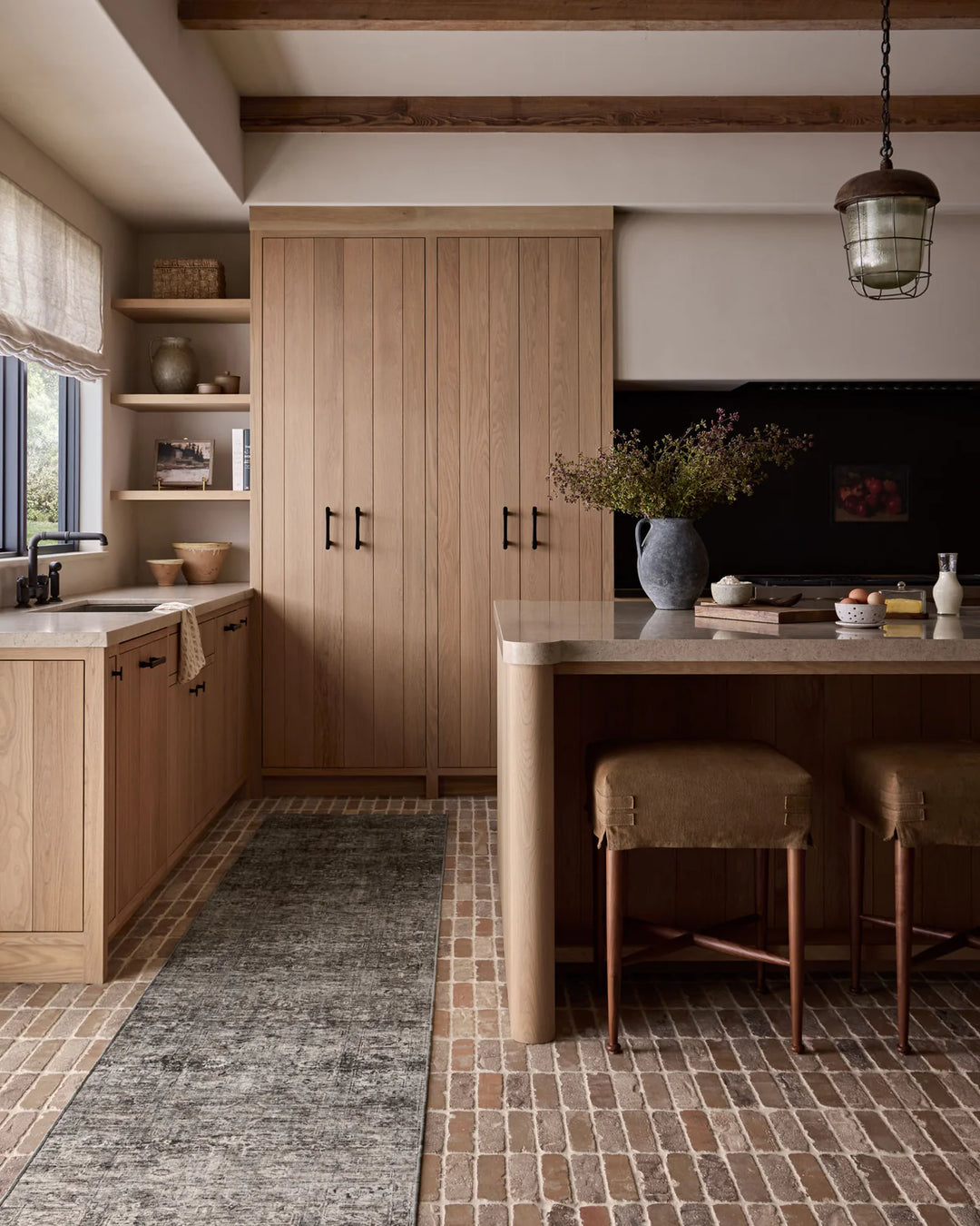 patterned rug with brown , blue, and burnt orange neutral tones