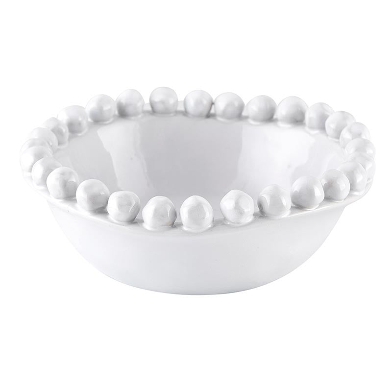 White ceramic bowl with bead-like embellishments on a white background