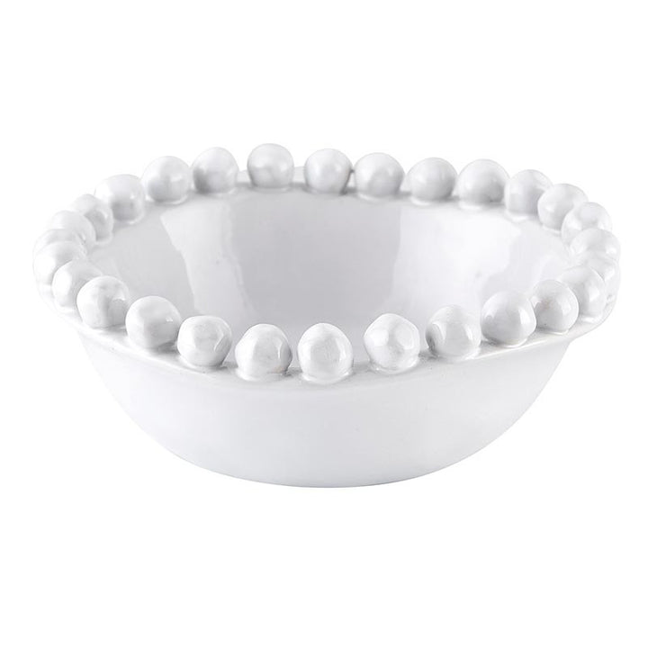 White ceramic bowl with bead-like embellishments on a white background