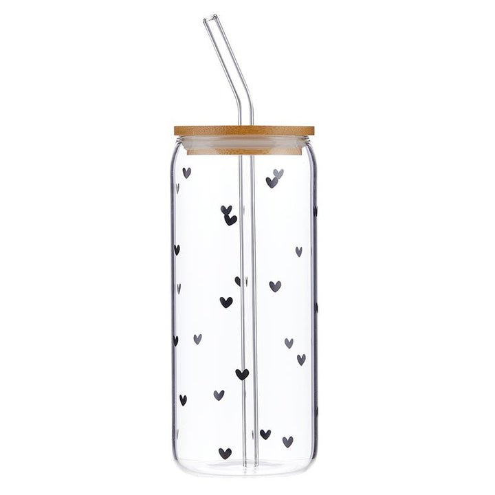 Clear tumbler with black heart patterns, wooden lid, and straw on a white background