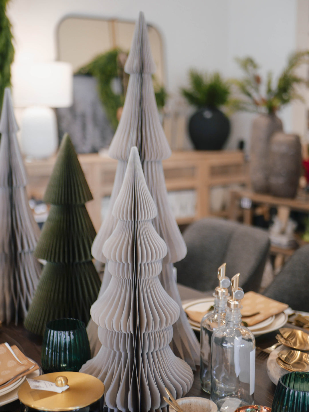 Decorative paper trees on a table with a blurred indoor setting
