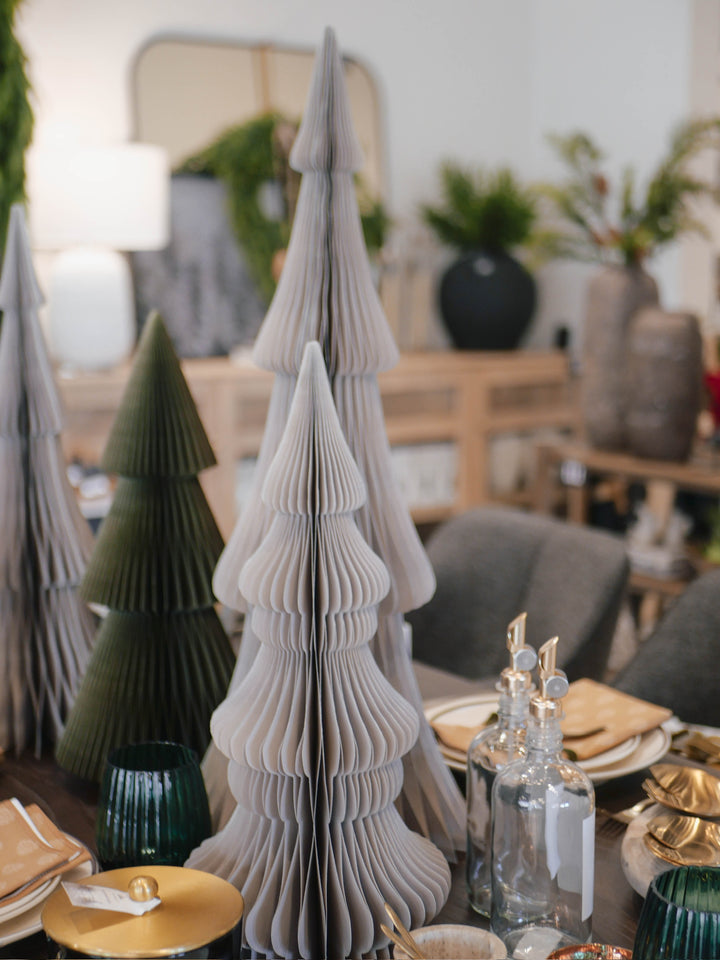 Decorative paper trees on a table with a blurred indoor setting