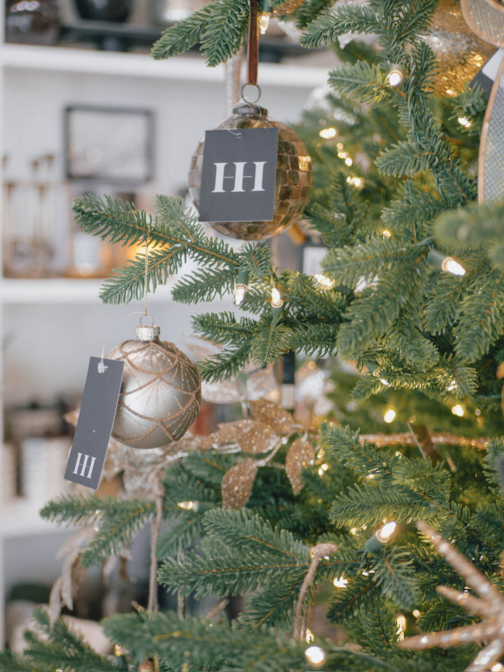 silver and gold ornament on christmas tree