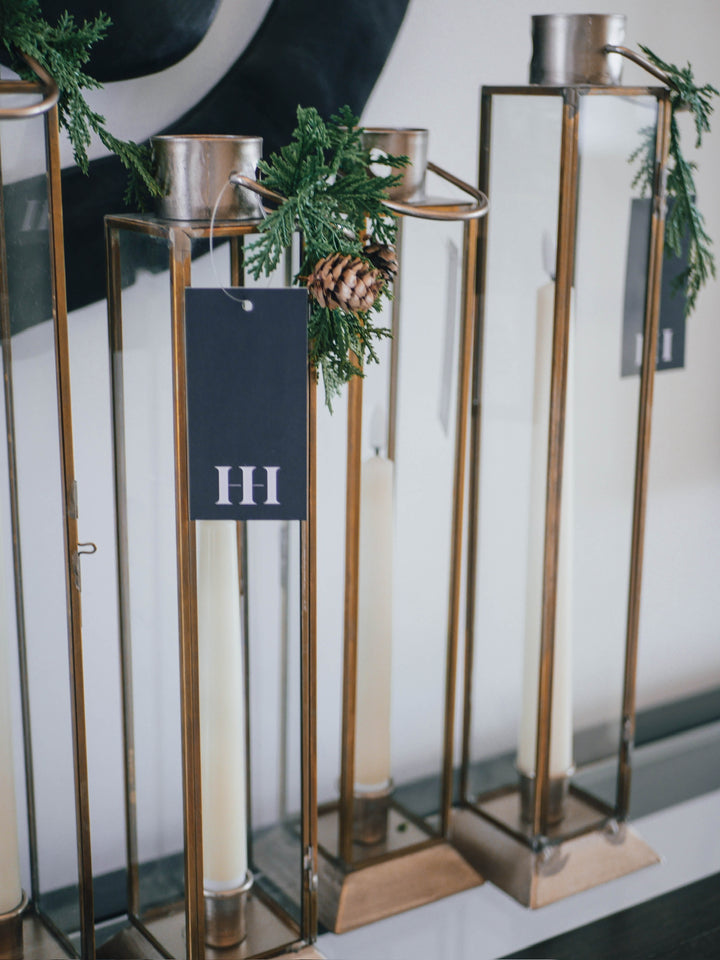 Decorative gold candle holders with greenery 
