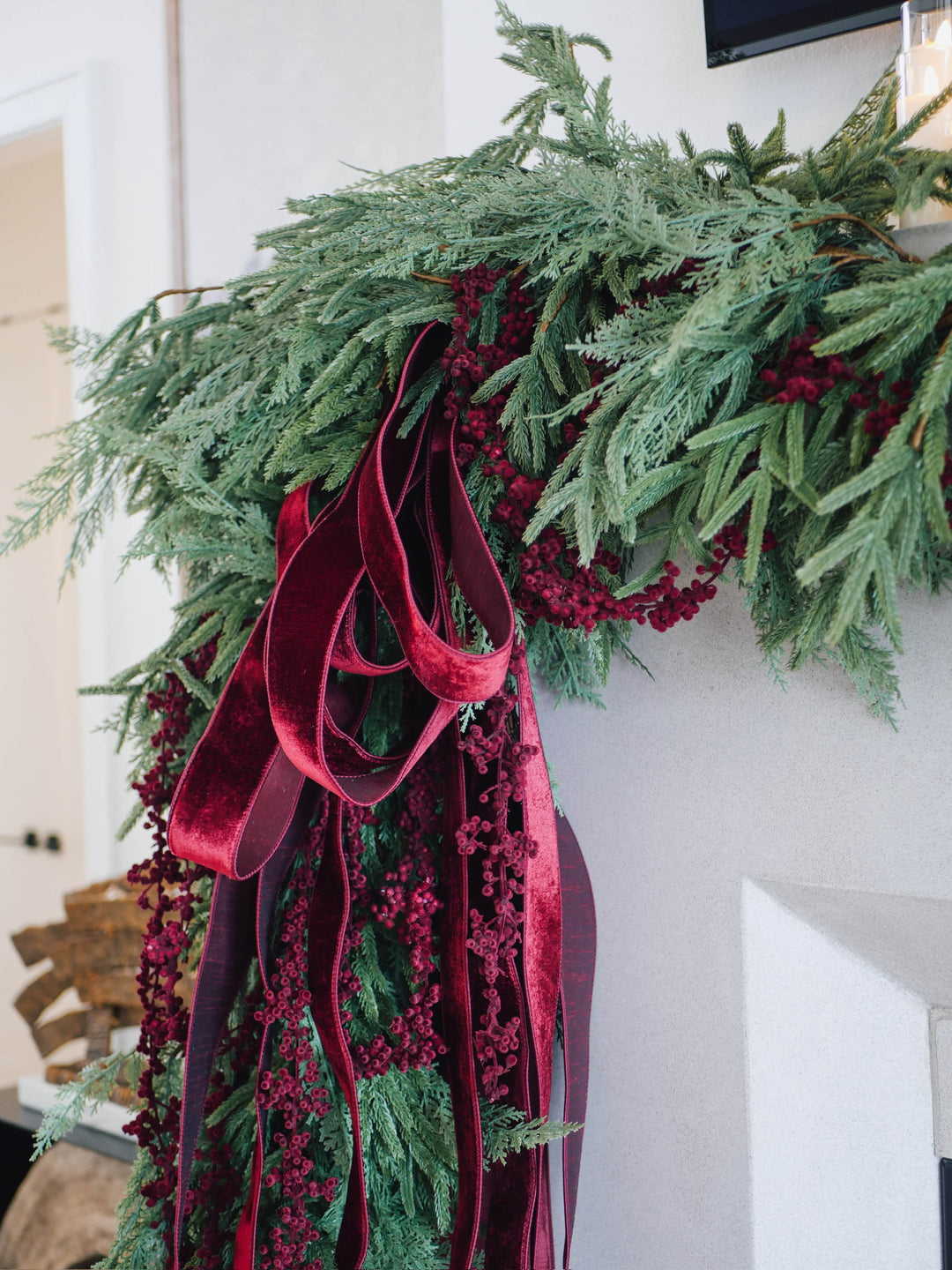 Decorative greenery with red ribbons on a mantle