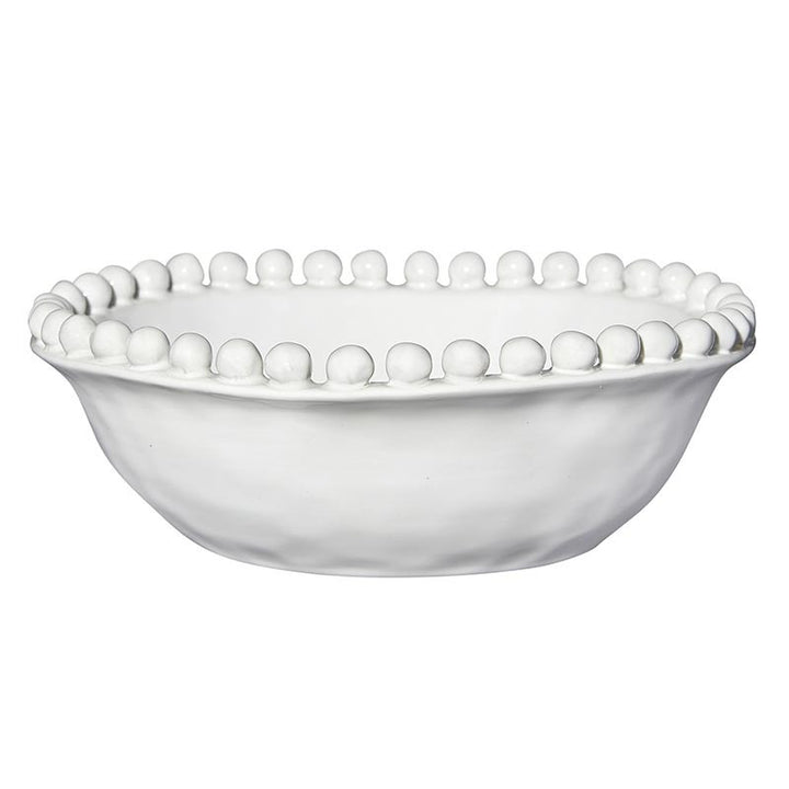 White ceramic bowl with decorative edge on a white background
