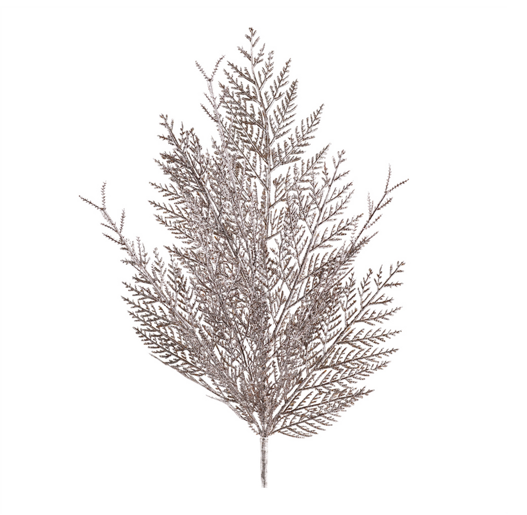 A glittered metallic cedar spray decoration with a silver finish and lifelike branches.