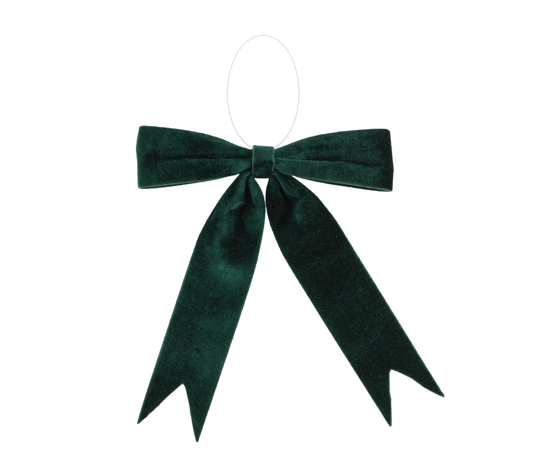A green velvet bow ornament with a red ribbon trim.