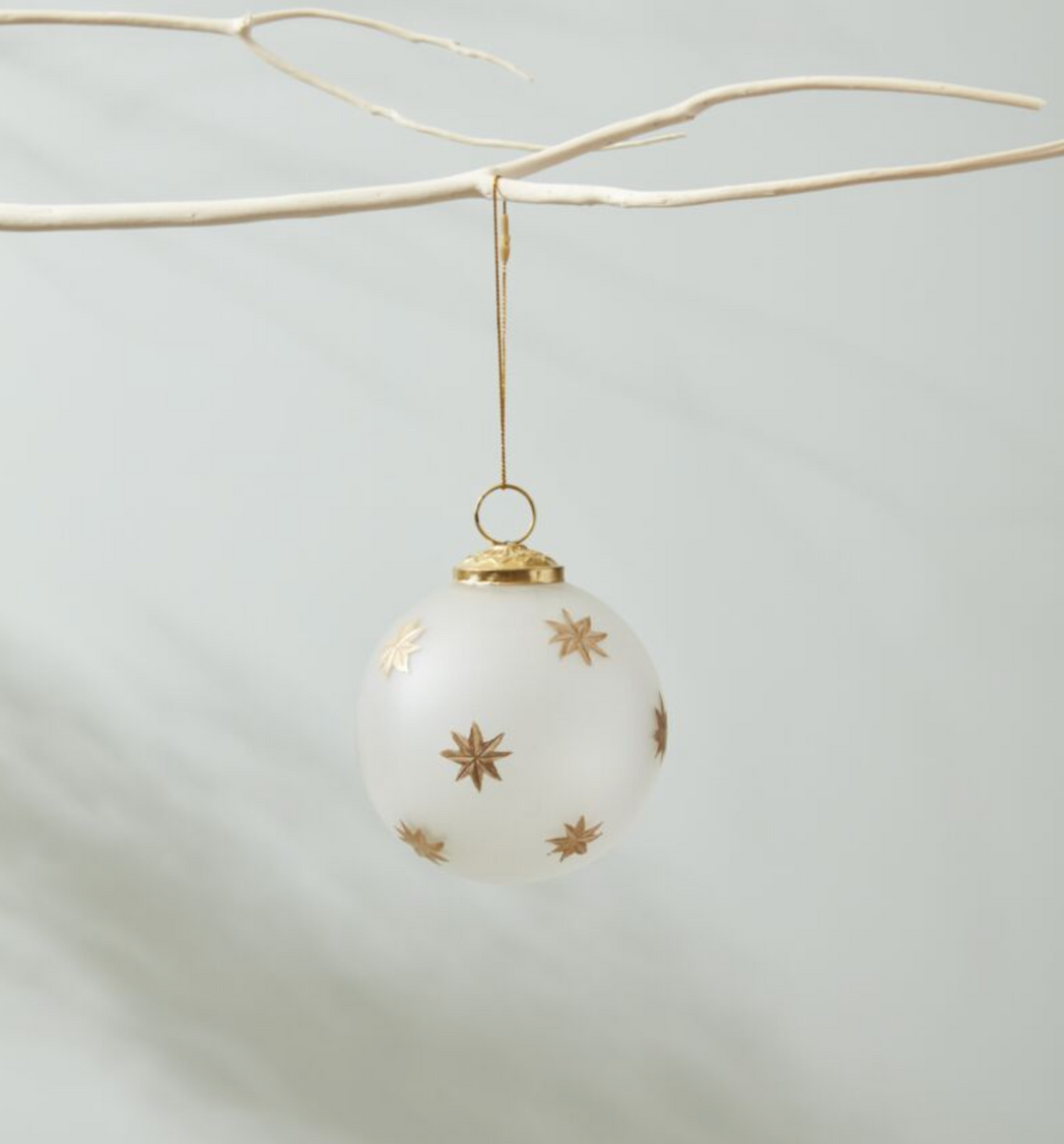 small frosted glass ornament with gold cap and loop and painted gold starbursts