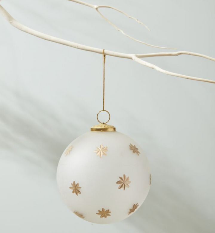 large frosted glass ornament with gold cap and loop and painted gold starbursts