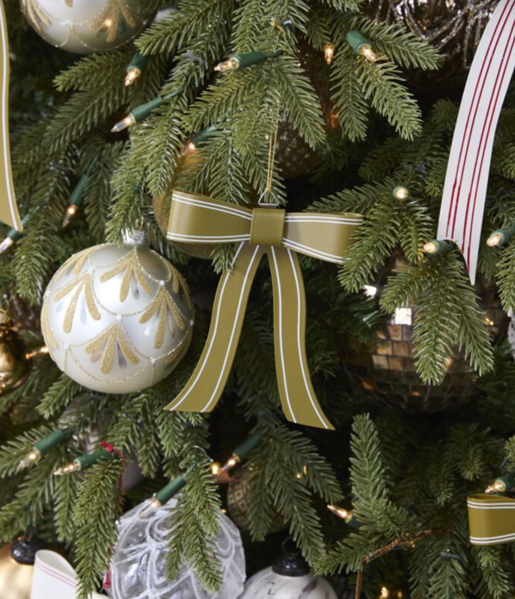 gold and white striped metal bow ornament hanging on a Christmas tree
