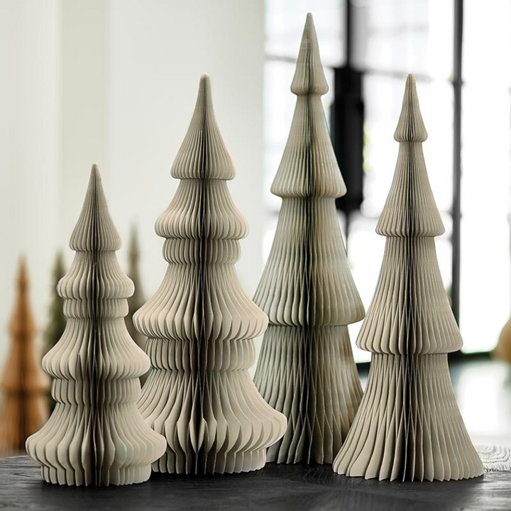 A set of three gray paper foldable Christmas trees displayed on a table.