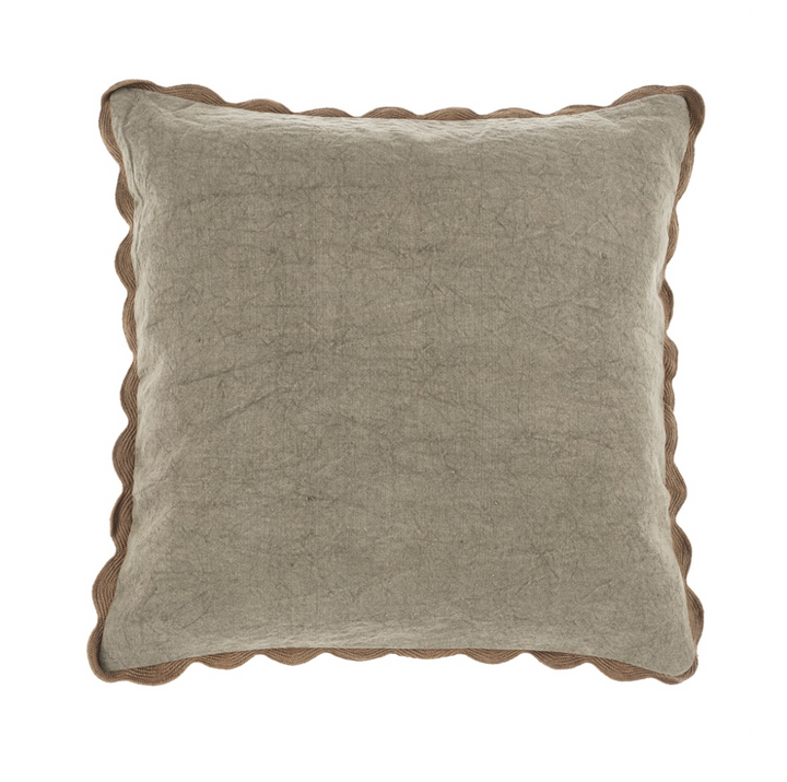 A square-shaped throw pillow with scalloped edges in shades of gray and beige.