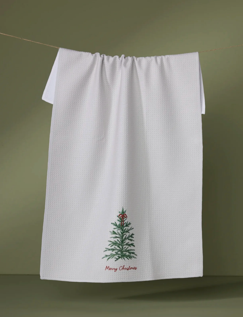 White towel with a Christmas tree design and 'Merry Christmas' text