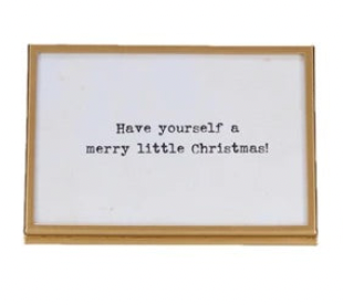 gold finish metal and glass frames with easels and Christmas-themed sayings written in them.