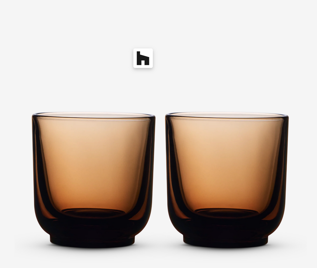 Two amber glass coffee cups on a white background