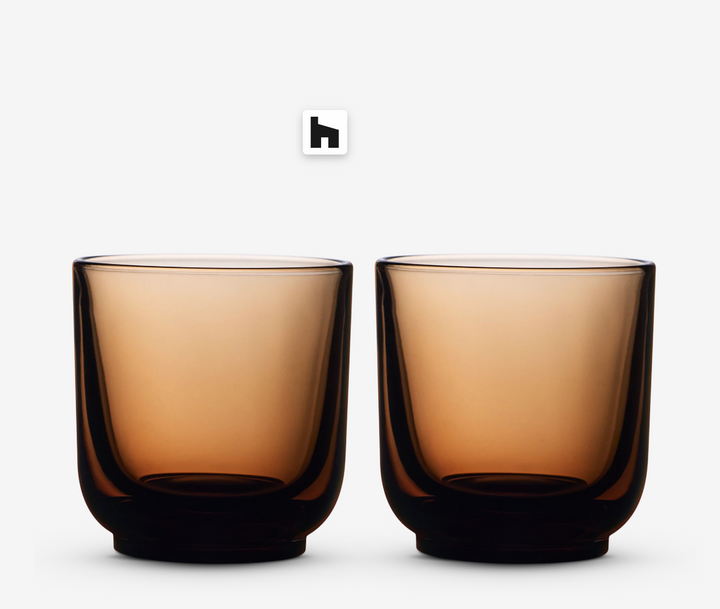 Two amber glass coffee cups on a white background