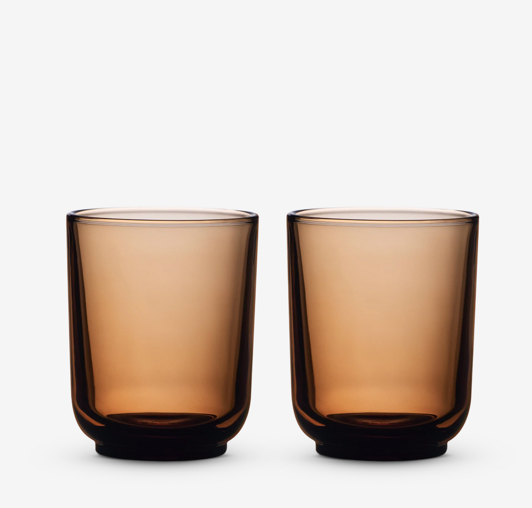 Two amber glass lattee coffee cups on a white background