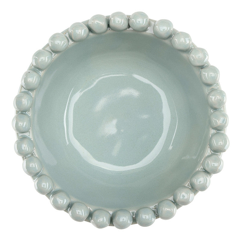 Light blue ceramic bowl with bead-like edge on a white background