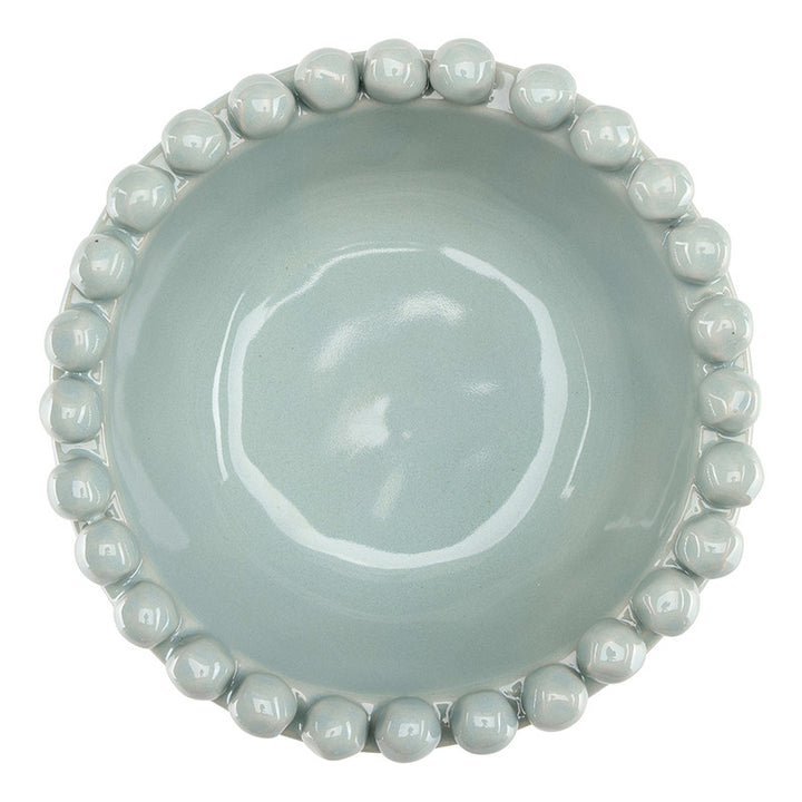 Light blue ceramic bowl with bead-like edge on a white background