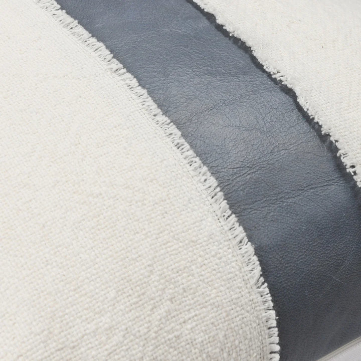 close up woven pillow with blue leather strip