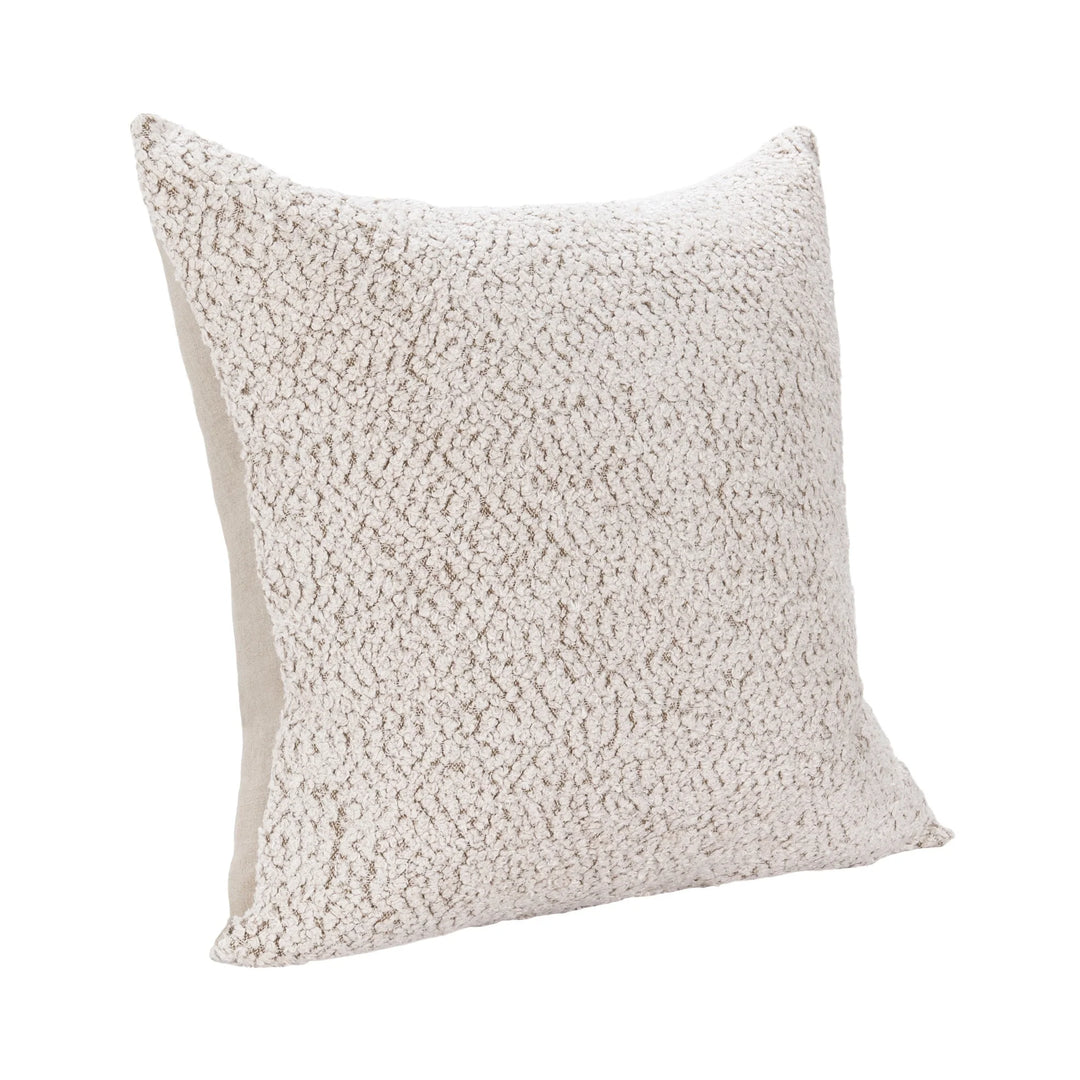 Textured beige pillow on a white background