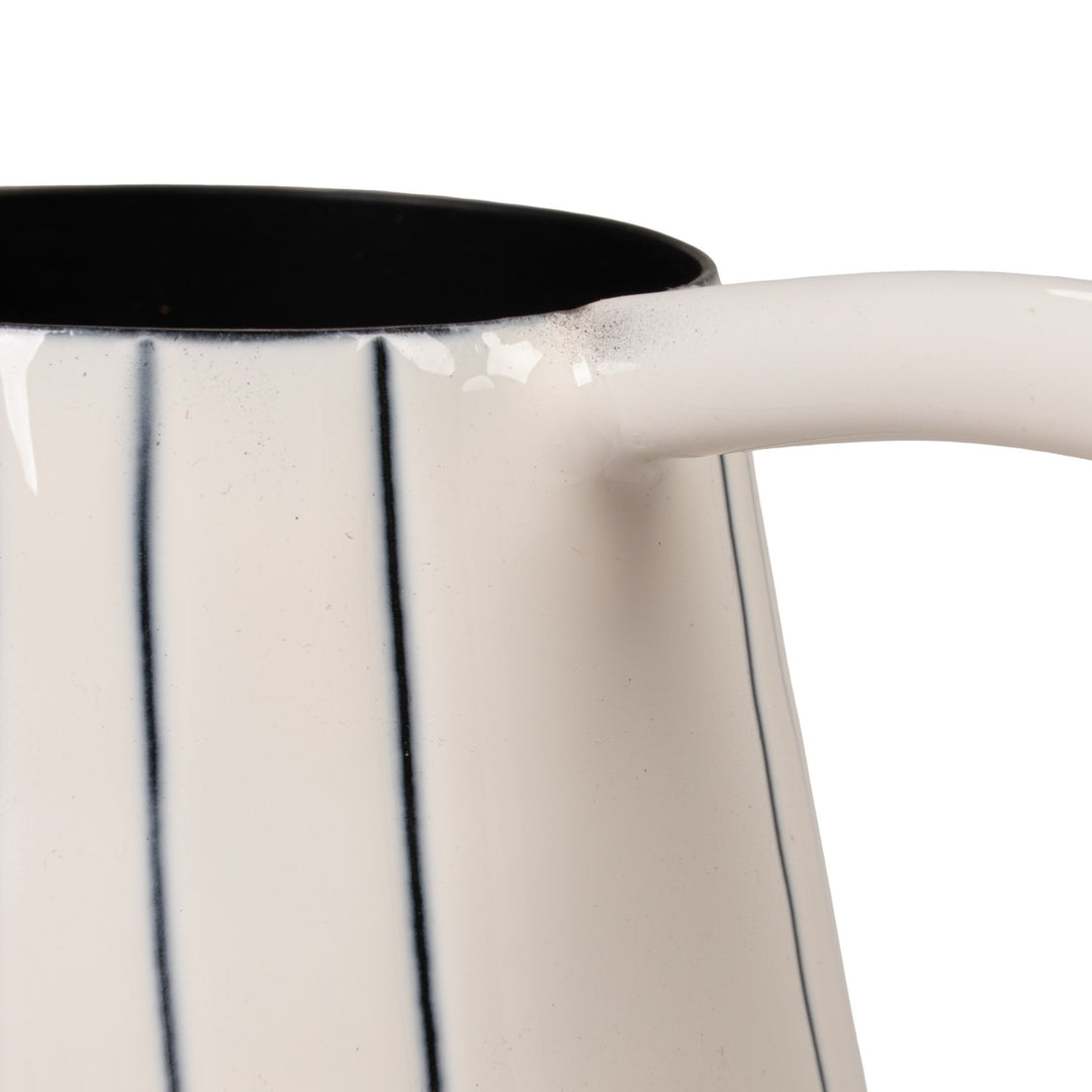 White ceramic watering can with blue stripes