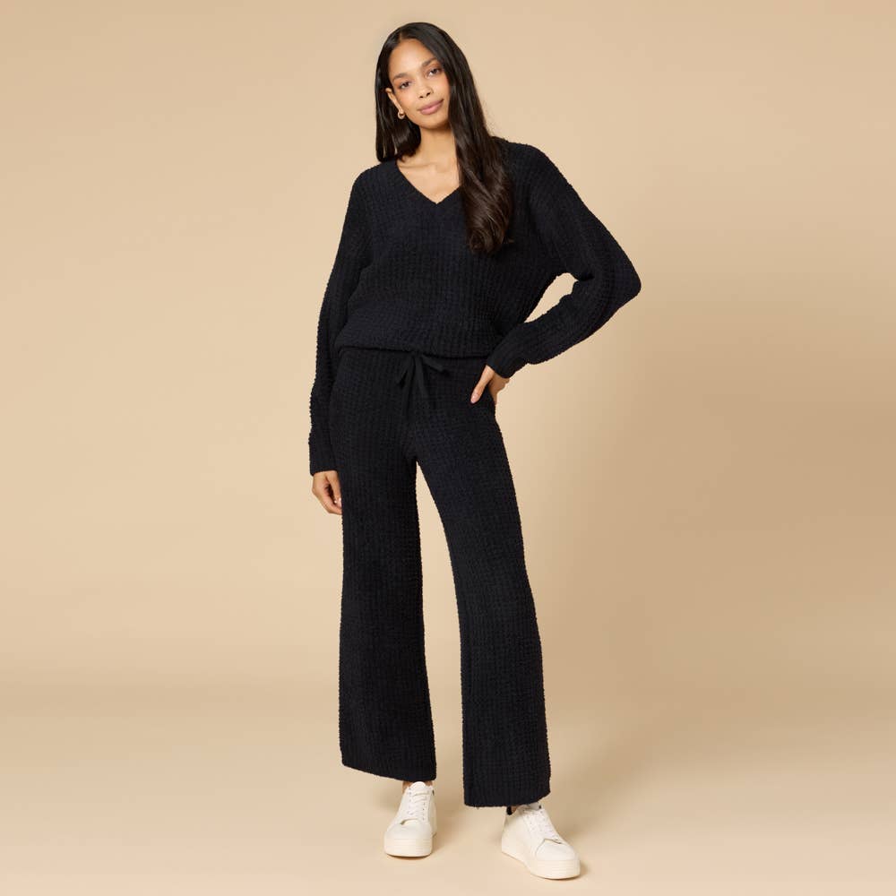 woman wearing black marshmellow waffle knit pajama set