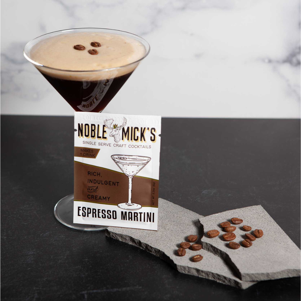 Noble Mick's Espresso Martini cocktail with a glass and packaging on a dark surface.