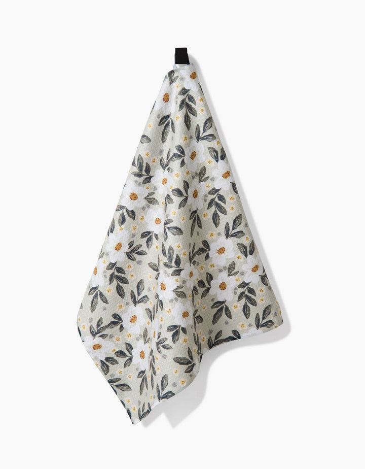 Floral patterned geometry towel with small flowers and leaves on a light background