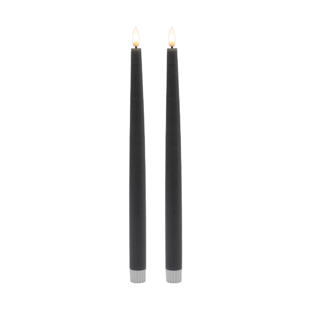 Two gray candles with silver bases on a white background