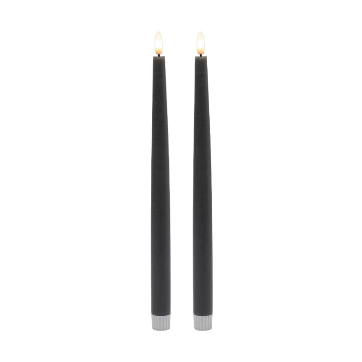 Two gray candles with silver bases on a white background