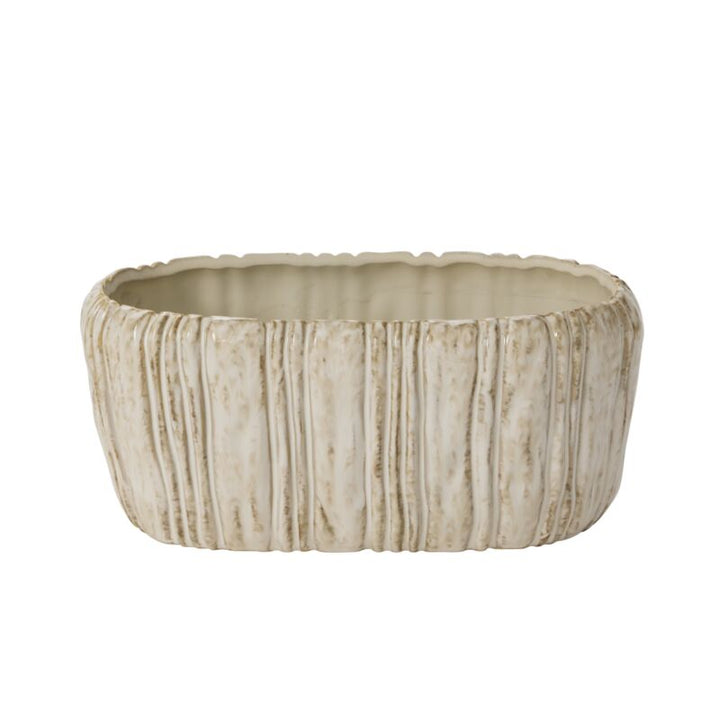 Beige ceramic planter with textured surface on a white background