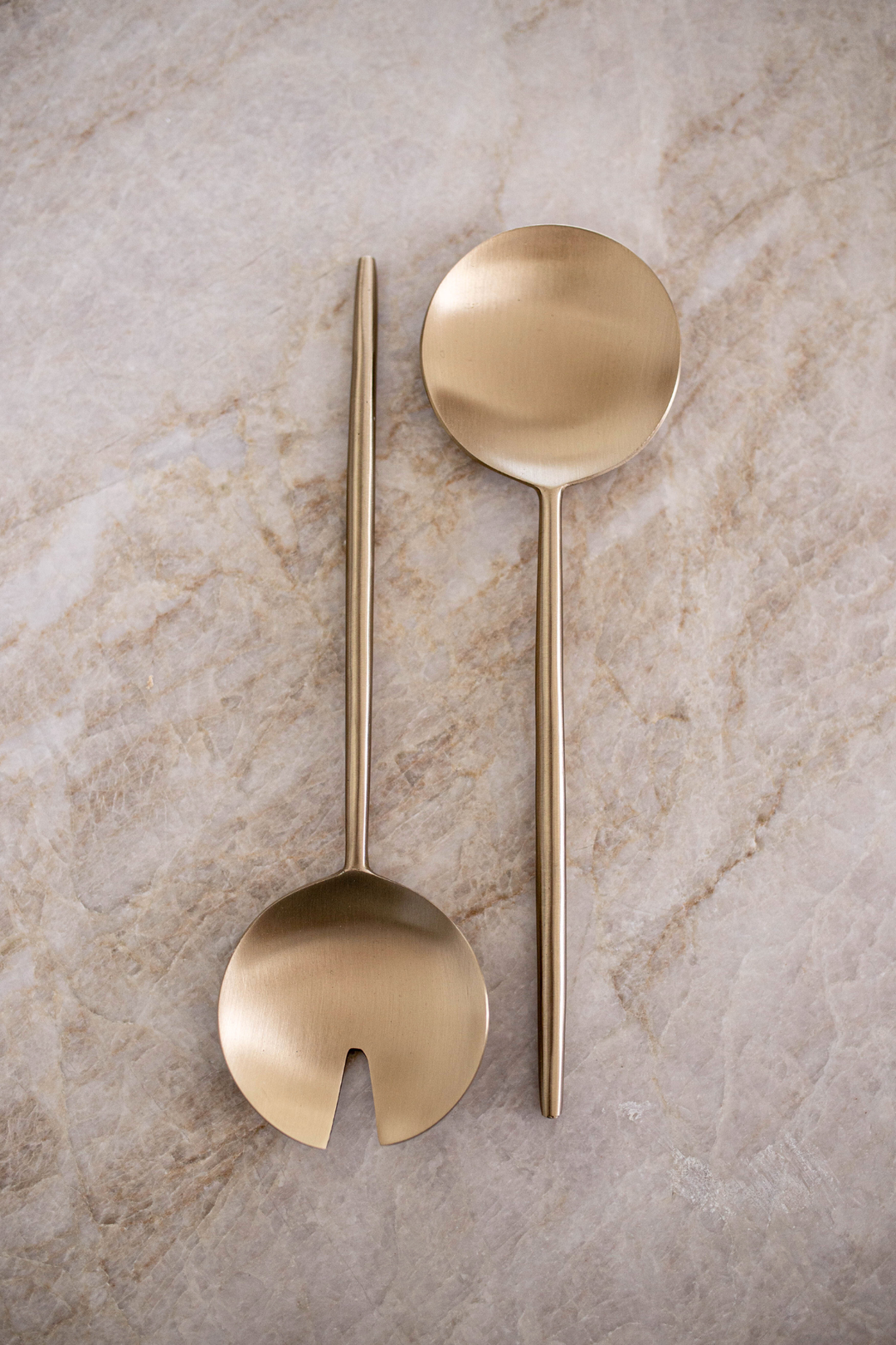 Two gold salad servers