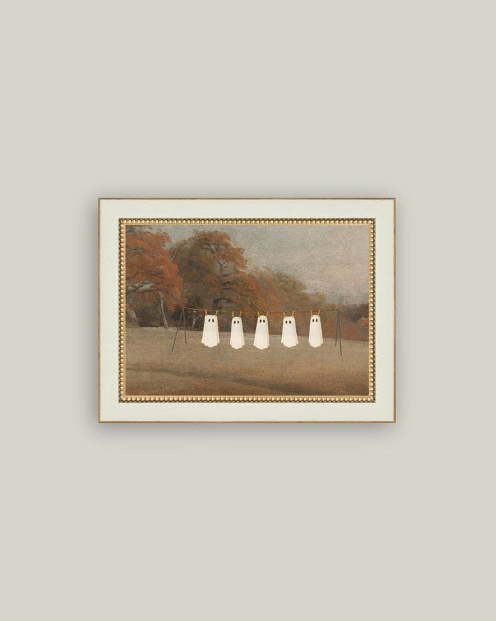 Framed artwork of three white figures on a path with trees in the background.