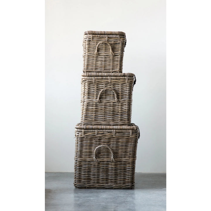 Stack of three wicker baskets on a gray surface with a white background