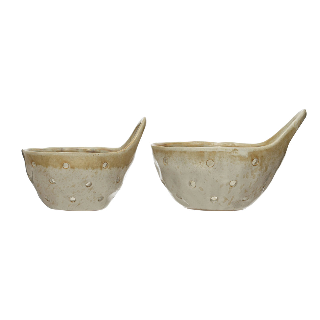 Two ceramic colanders with a glossy surface on a white background