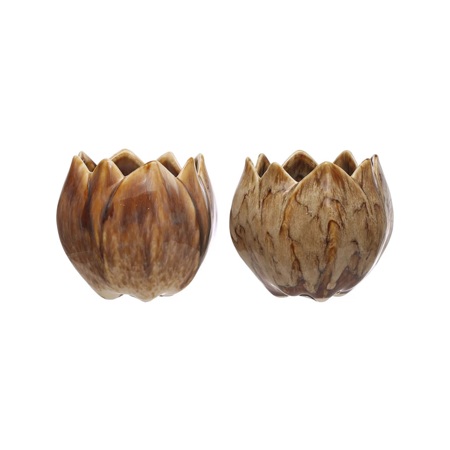 Two wooden lotus flower-shaped candle holders on a white background