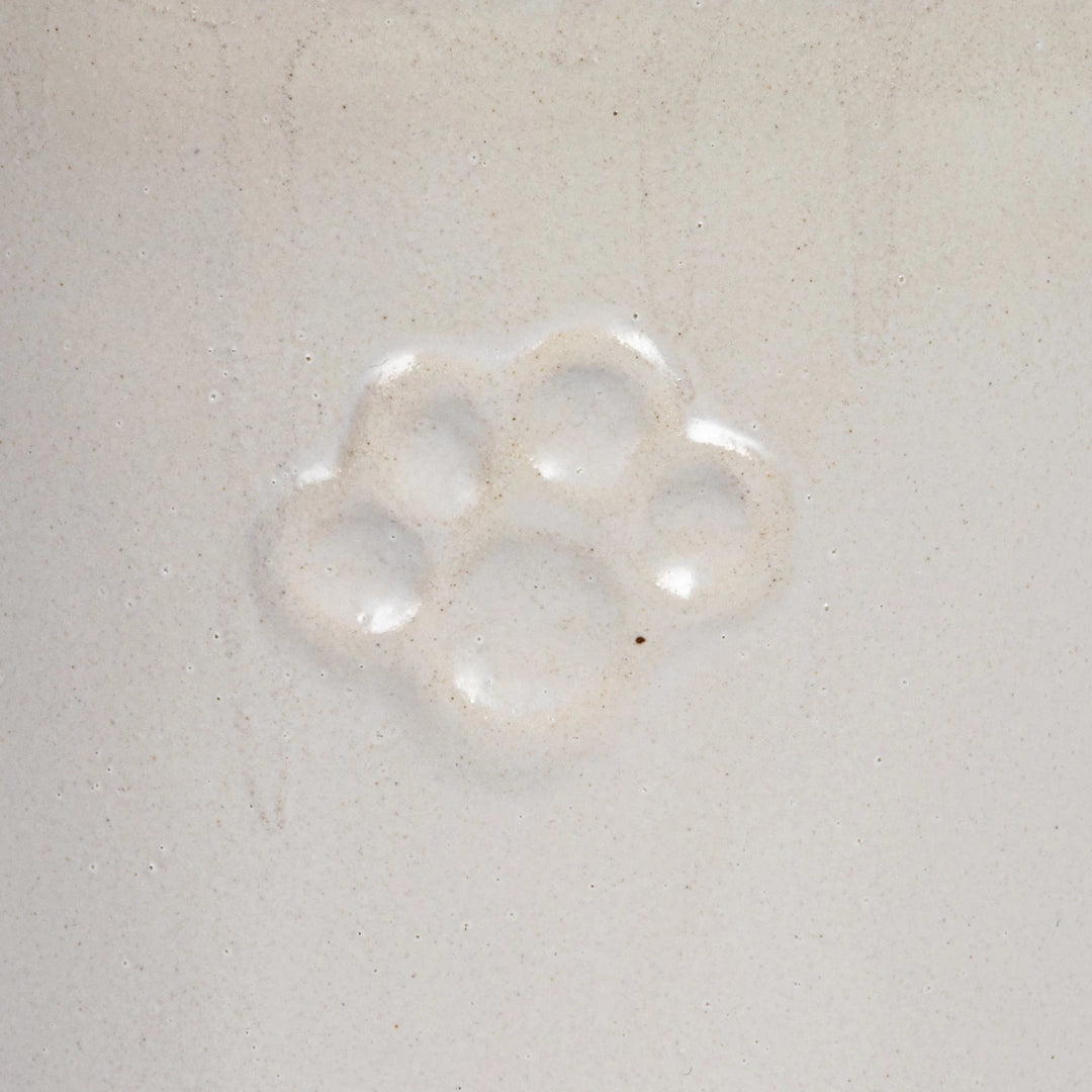 close up white ceremic dog treat canister