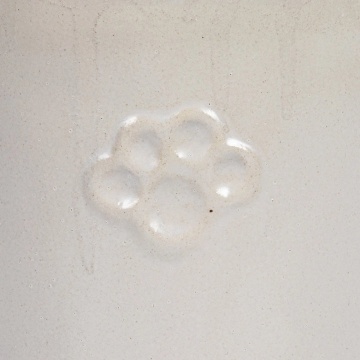 close up white ceremic dog treat canister
