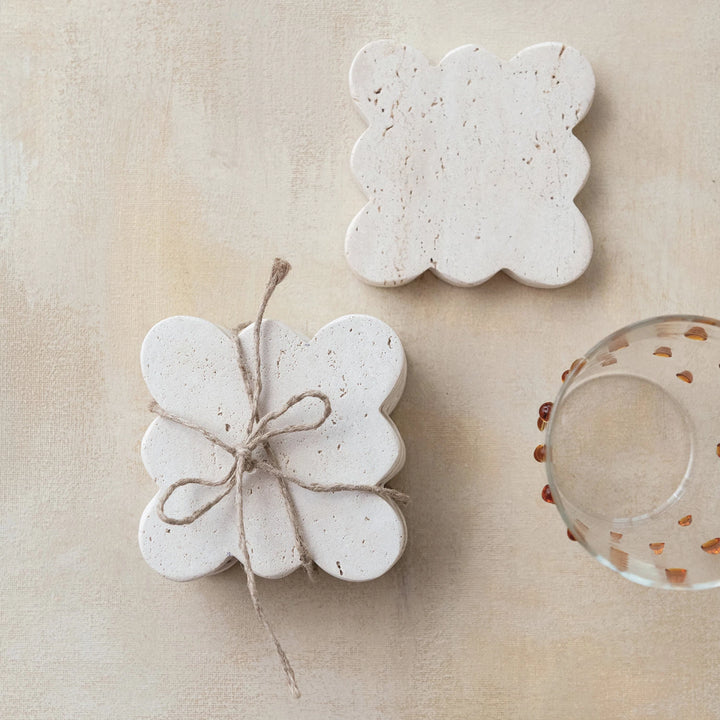 Two scalloped stone coasters 