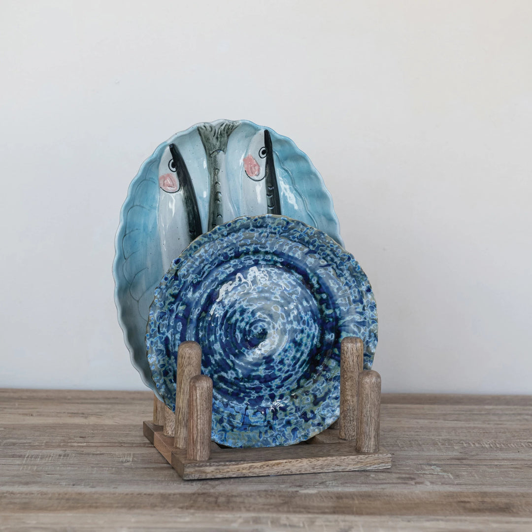 wooden plate stand holding two blue plates