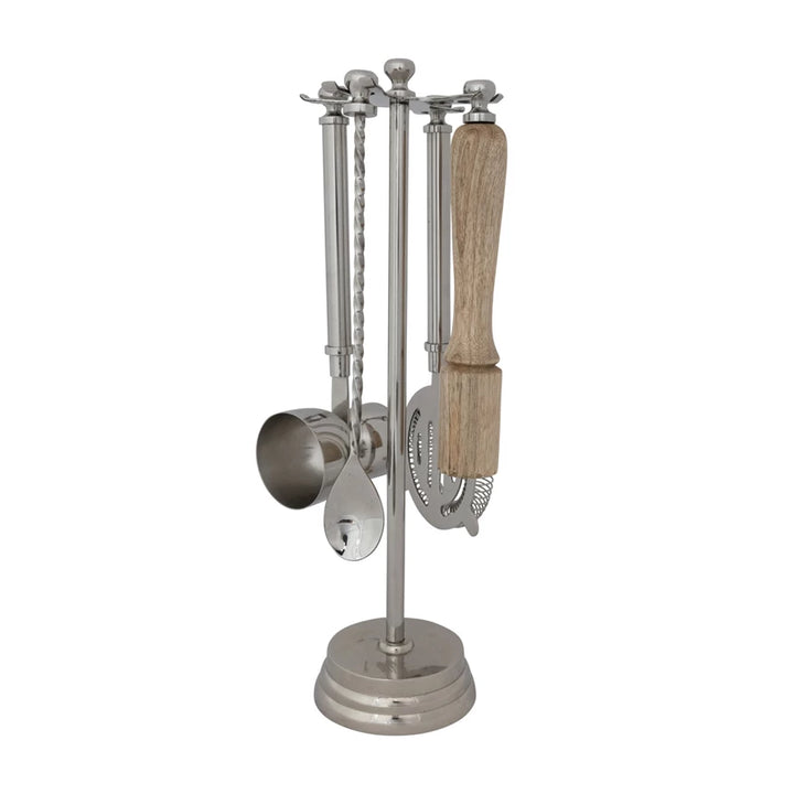 Set of kitchen utensils including a jigger, spoon, and strainer, muddler on a stand with a wooden handle.