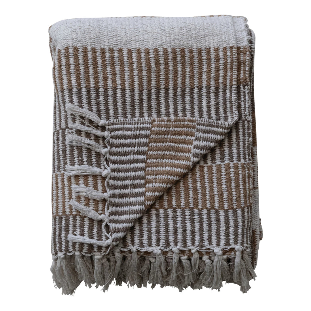 folded woven throw with stripes and fringes
