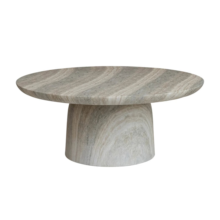 Round marble table with a textured surface