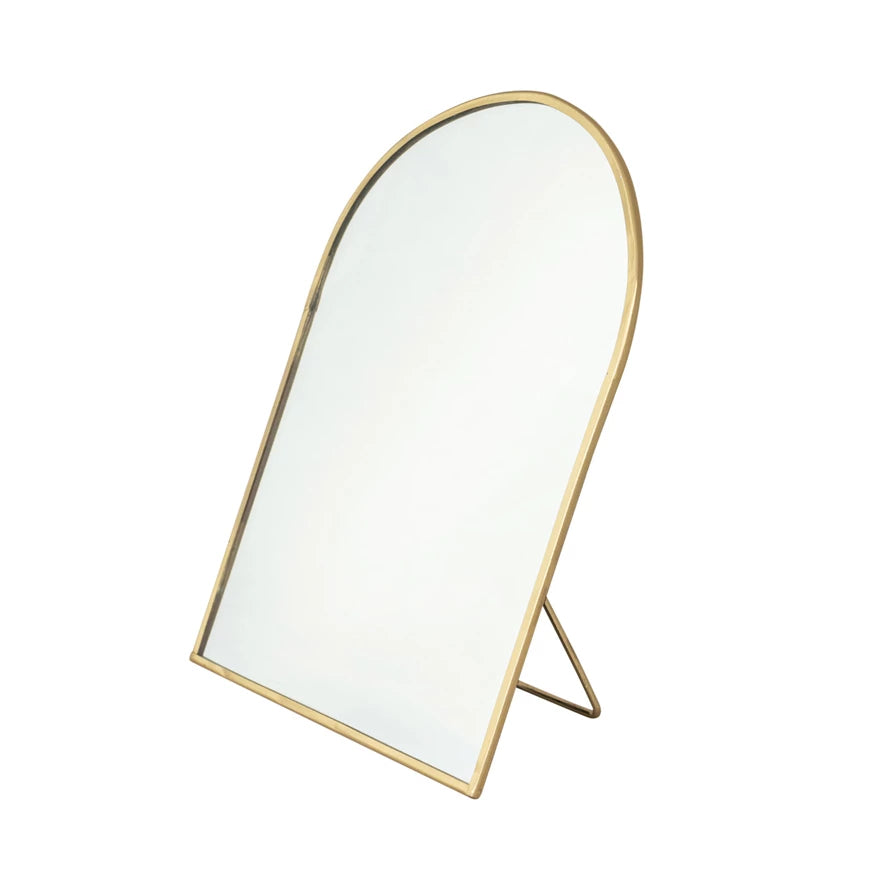 Gold-framed mirror on a white background