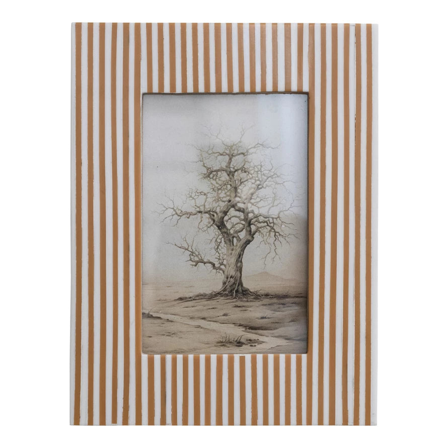 white and caramel color striped frame with a picture of a dead tree