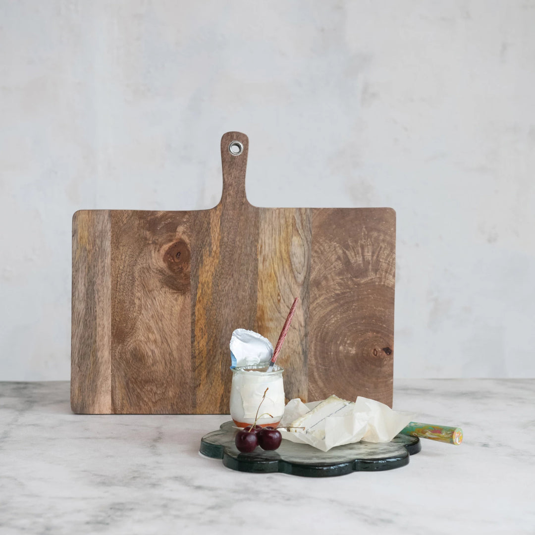 large wooden cutting board with handle